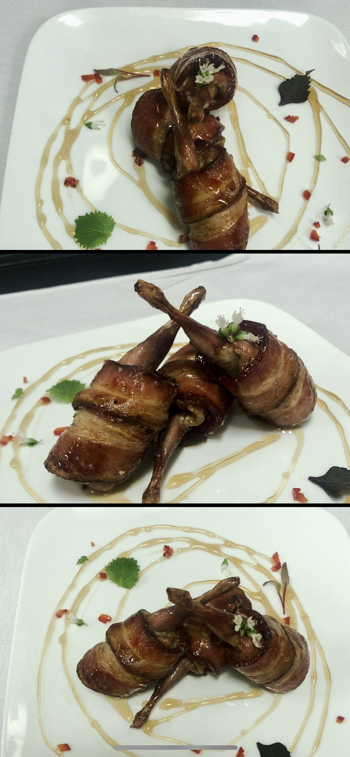 Bacon-wrapped quail with a honey glaze, plated with edible flowers